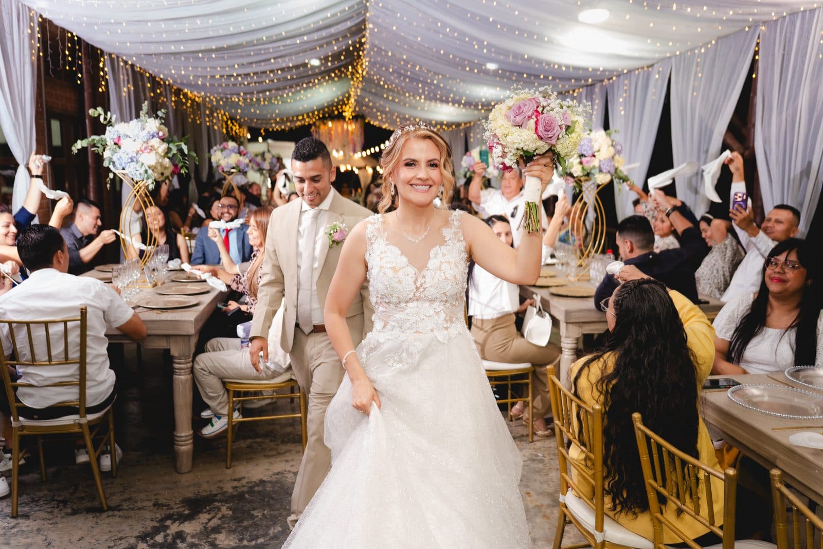 Bride entering the reception among her guests