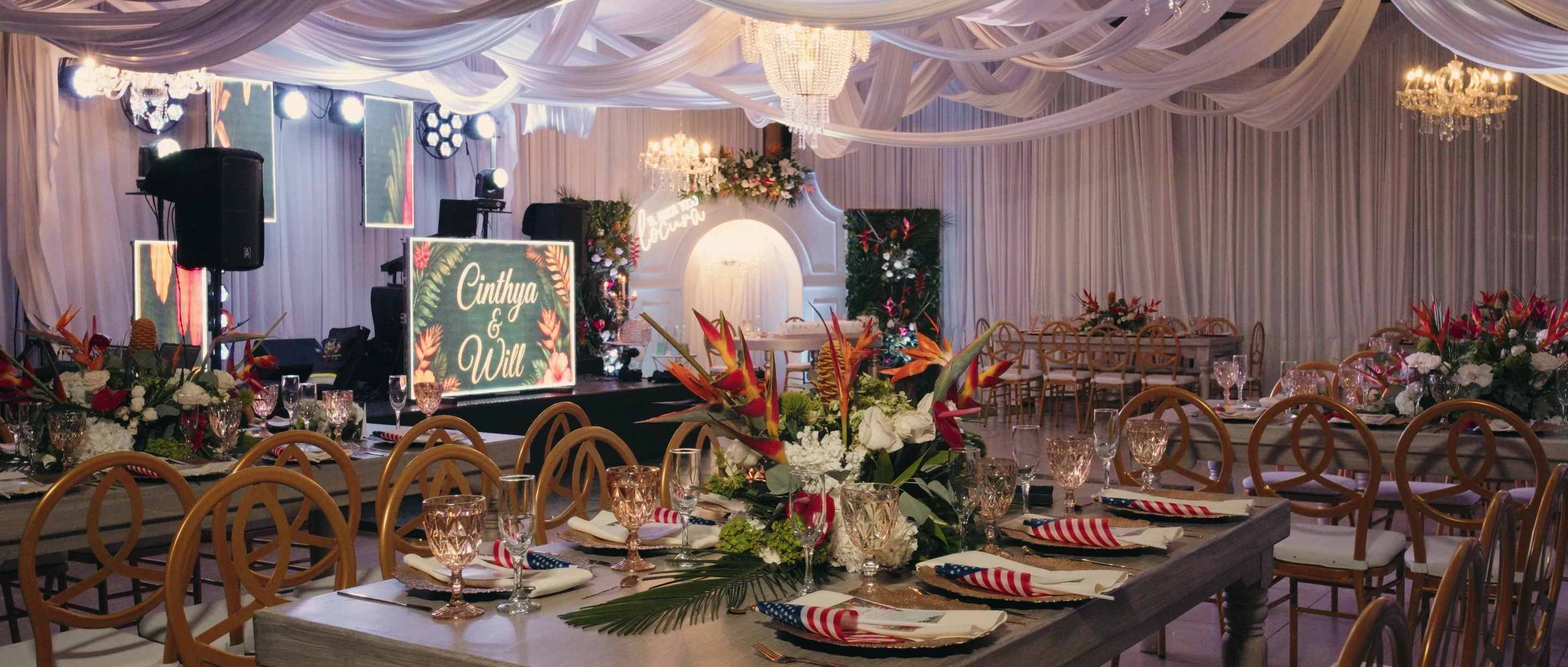 Reception hall at an Altagracia wedding, with tables set and tropical flowers